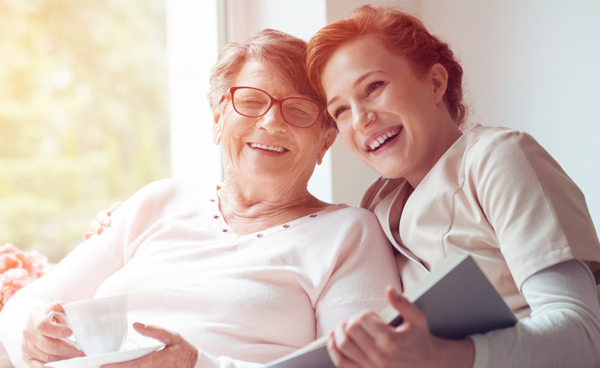 caregiver and her patient enjoy reading