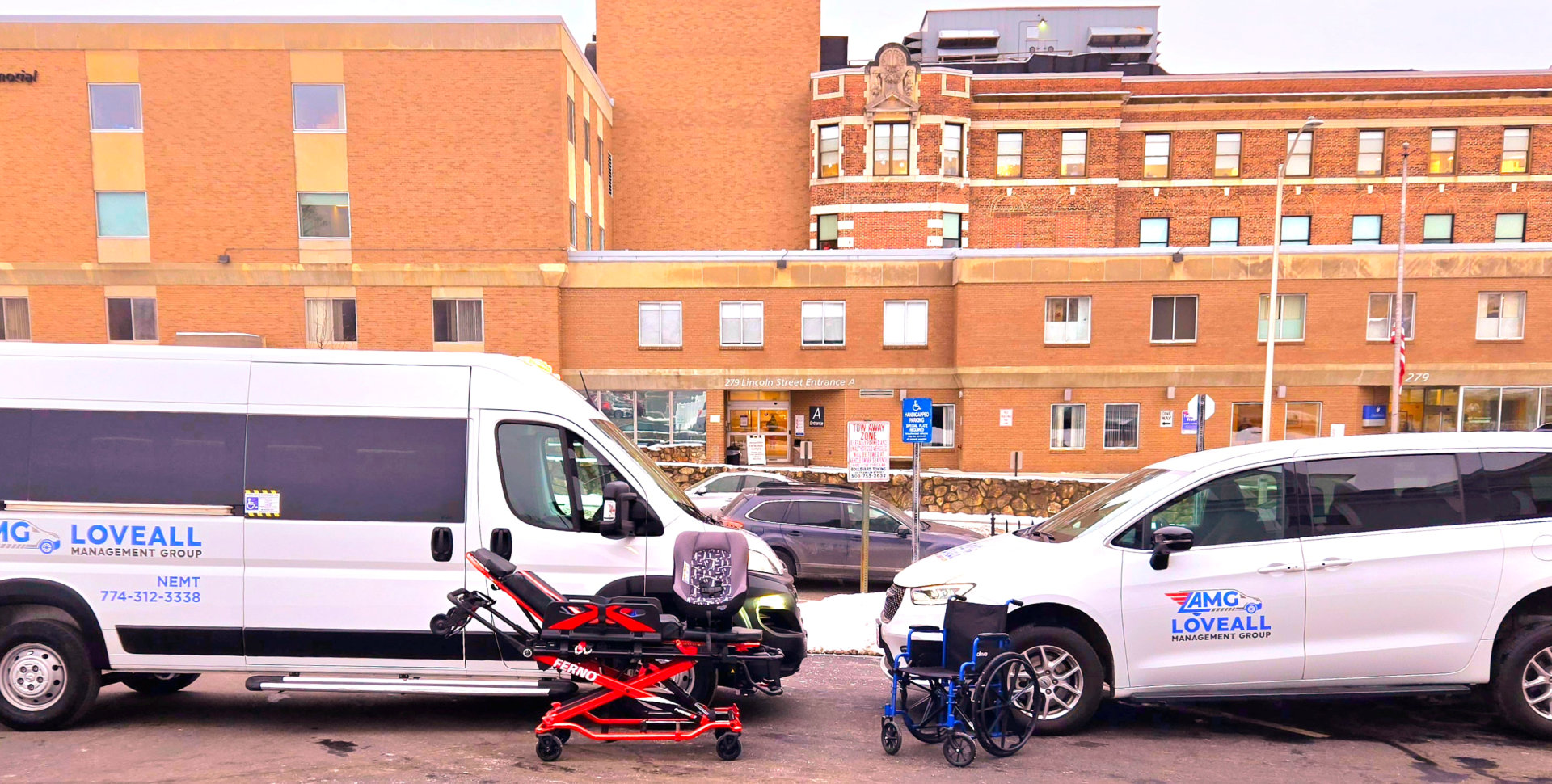 two white transportation cars and a emergency bed in front