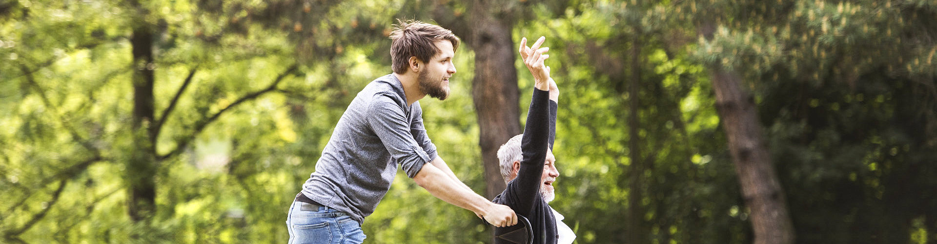 man and his grandfather on a wheelchair bond outside the house