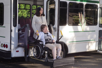 woman assist her mother going out from the car