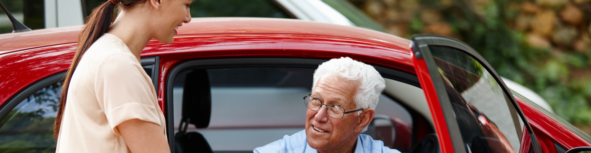 woman assist her father in going out from the car